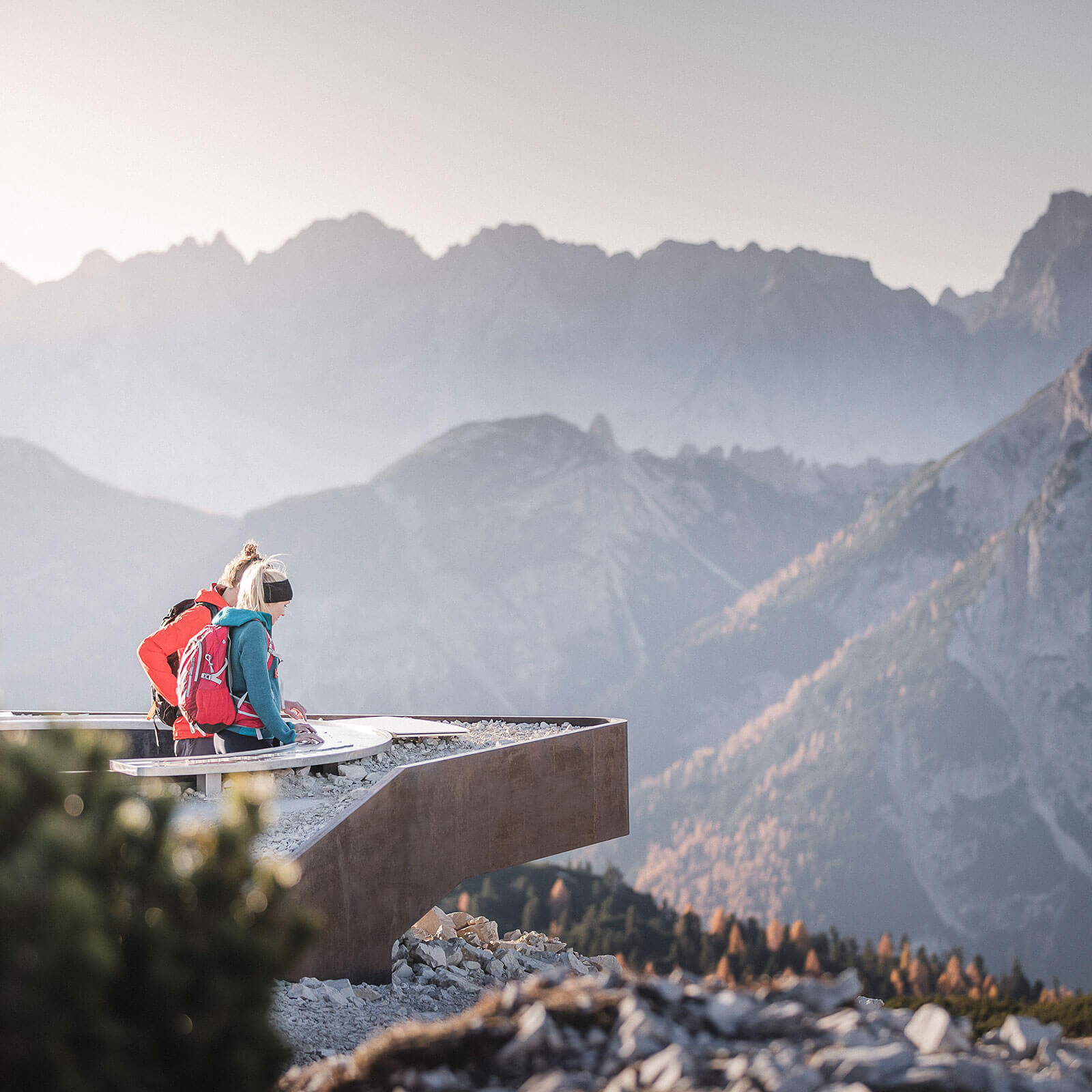 Two hikers admiring the mountain panorama